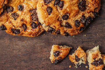 Chocolate cookies with crumbs on dark wooden table. Brown Chocolate chip cookies top view.