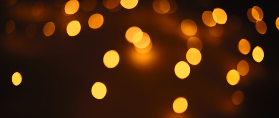 Christmas dark  glowing Golden Abstract Background. Blurred Xmas Bokeh lights