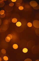 Christmas dark  glowing Golden Abstract Background. Blurred Xmas Bokeh lights