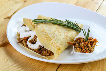 Pancake with minced meat and sauce
