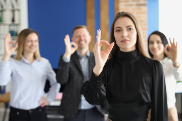 Coworkers showing ok gesture with hands good teamwork and successful work
