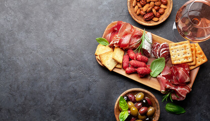 Antipasto board with prosciutto, salami, crackers, cheese, olives