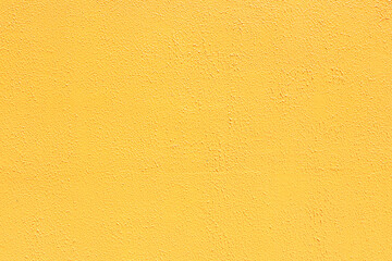 Saturated yellow colored low contrast Concrete textured background with roughness and...