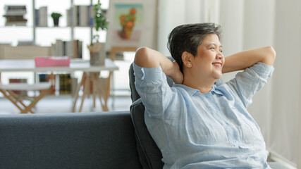 Mature Asian female resting on couch