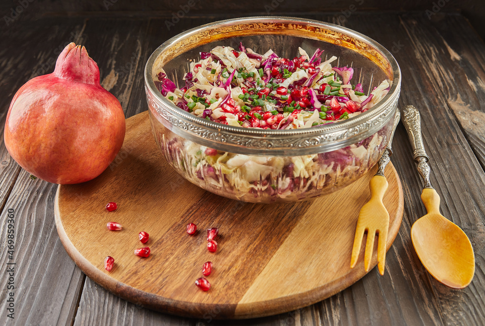 Canvas Prints Cabbage salad of two colors with pomegranate seeds and salted nuts. French gourmet cuisine