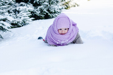Fototapeta na wymiar Little girl having fun at winter day on the big snow. Outdoor fun for family Christmas vacation. Winter activities for kids. Cute toddler enjoying a day out playing in the winter forest