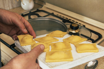 Staying at home and cooking. Homemade Italian pumpkin ricotta ravioli, ravioli cooking process.