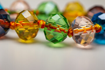 Full frame macro abstract texture background of a string of defocused multicolor glass beads on...