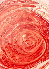 Mixing of red and white water-based paint.