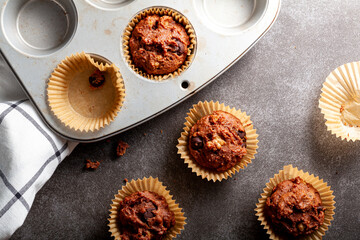 Fruit and nut chocolate cupcakes in liners and nonstick tray served fresh out of oven for breakfast...