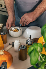 Staying at home and cooking. Homemade Italian pumpkin ricotta ravioli. Men making pumpkin ricotta filling for ravioli.