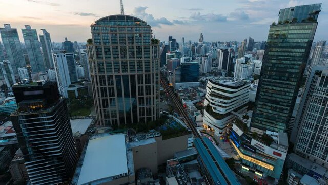 aerial view of ฺPhrom Phongintersection or junction with cars traffic skyscraper buildings. Bangkok City in downtown at night, Thailand. 