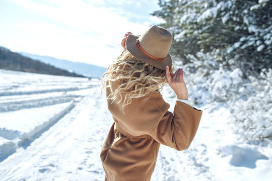 Woman travels in winter. Beautiful girl in the winter in nature. High quality photo