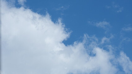 View of beautiful blue sky background with white clouds at the noon, Bangkok, Thailand.