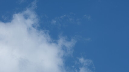 View of beautiful blue sky background with white clouds at the noon, Bangkok, Thailand.