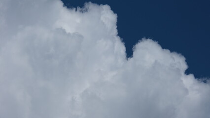 View of beautiful blue sky background with white clouds at the noon, Bangkok, Thailand.
