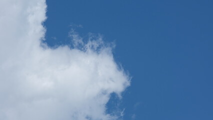 View of beautiful blue sky background with white clouds at the noon, Bangkok, Thailand.