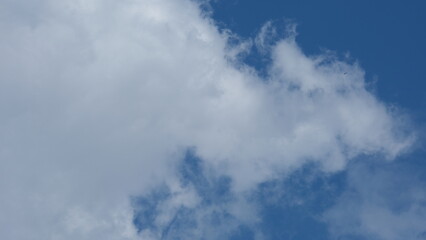 View of beautiful blue sky background with white clouds at the noon, Bangkok, Thailand.