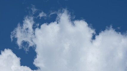 View of beautiful blue sky background with white clouds at the noon, Bangkok, Thailand.