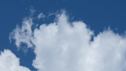 View of beautiful blue sky background with white clouds at the noon, Bangkok, Thailand.
