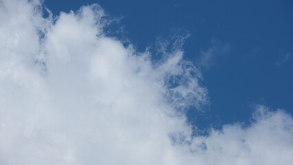 View of beautiful blue sky background with white clouds at the noon, Bangkok, Thailand.