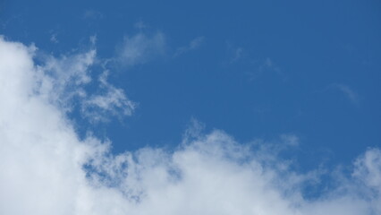 View of beautiful blue sky background with white clouds at the noon, Bangkok, Thailand.