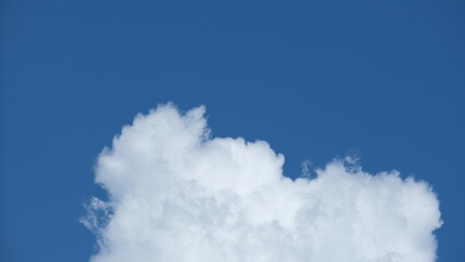 View of beautiful blue sky background with white clouds at the noon, Bangkok, Thailand.