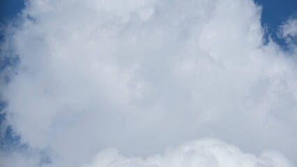 View of beautiful blue sky background with white clouds at the noon, Bangkok, Thailand.