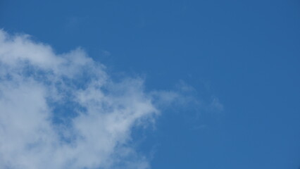 View of beautiful blue sky background with white clouds at the noon, Bangkok, Thailand.