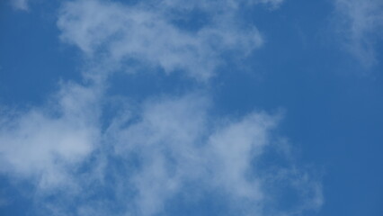 View of beautiful blue sky background with white clouds at the noon, Bangkok, Thailand.