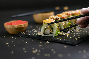 Hot fried Sushi Roll with shrimps, avocado, lettuce and cheese. Sushi menu. Japanese food.