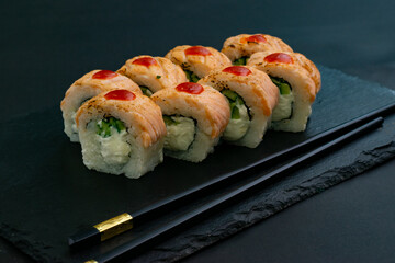 Grilled Philadelphia roll sushi with salmon, prawn, avocado, cream cheese. Sushi menu. Japanese food.