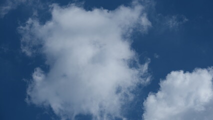 View of beautiful blue sky background with white clouds at the noon, Bangkok, Thailand.