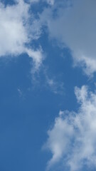 View of beautiful blue sky background with white clouds at the noon, Bangkok, Thailand.