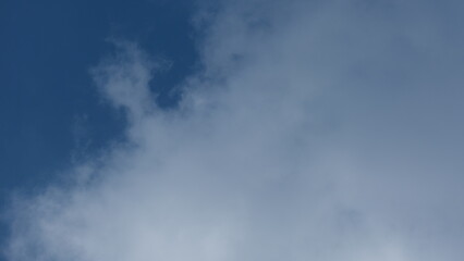 View of beautiful blue sky background with white clouds at the noon, Bangkok, Thailand.