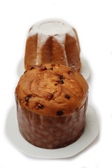 Traditional italian Christmas cakes called Pandoro and Panettone on  plates on white background