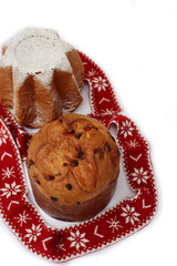 Traditional italian Christmas cakes called Pandoro and Panettone on  plates with festive decorations on white background