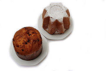 Traditional italian Christmas cakes called Pandoro and Panettone on  plates on white background