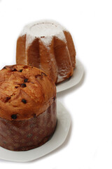 Traditional italian Christmas cakes called Pandoro and Panettone on  plates on white background
