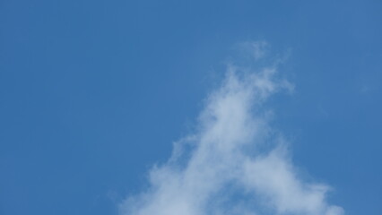 View of beautiful blue sky background with white clouds at the noon, Bangkok, Thailand.
