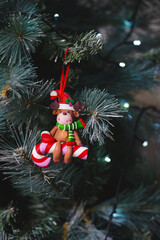 A Christmas decoration featuing a reindeer on a candy cane