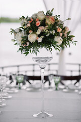 Wedding bouquet of delicate color close-up. White and Wedding bouquet of delicate color on the table in glass vase close-up. White and pink roses.