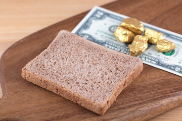 Bread and dollar bills on cutting board