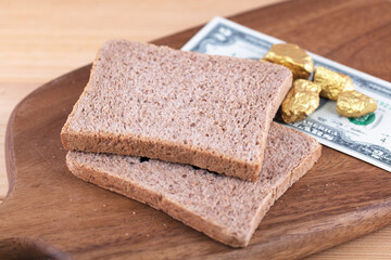 Bread and dollar bills on cutting board