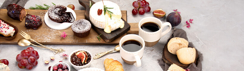 French desserts assortment on gray background.