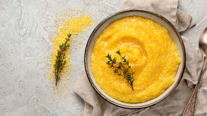 Corn polenta on gray background.