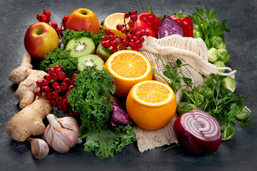 Foods high in vitamin C on dark background.