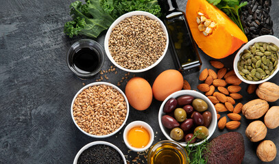 Obraz na płótnie Canvas Foods high in vitamin E on dark background.