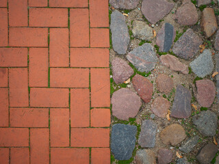 Sidewalk with different coverings. Red paving stones and granite cobblestones.