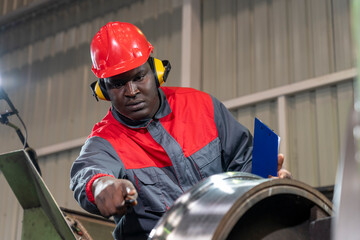 African American CNC Machine Operator In Protective Workwear Monitoring The Train Wheel...